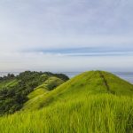 Pulau Diyonumo di Gorontalo Utara menyuguhkan hamparan rumput hijau di puncak bukit. Pulau perawan tanpa fasilitas wisata ini bisa dicapai dengan kapal nelayan/Foto: Indonesia Kaya